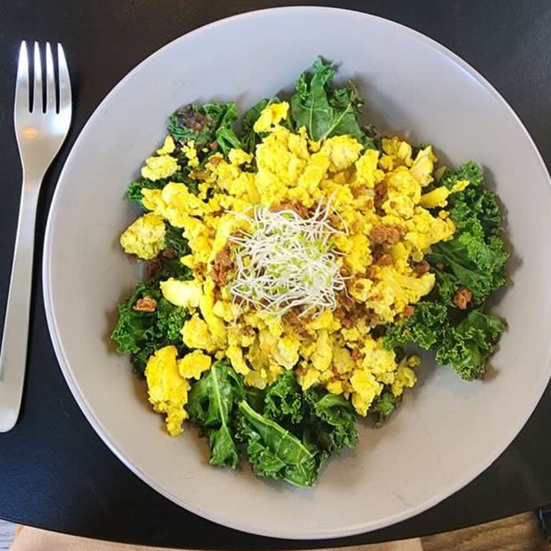 Tofu Scramble Over Kale topped with Super Team Protein Bar and Sprout